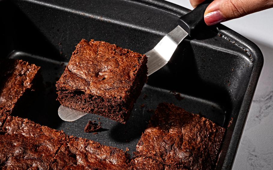 A metal pan and an offset spatula are the best brownie tools of engagement. Metal is a better conductor than glass, meaning things like brownies will bake quicker and more evenly. 