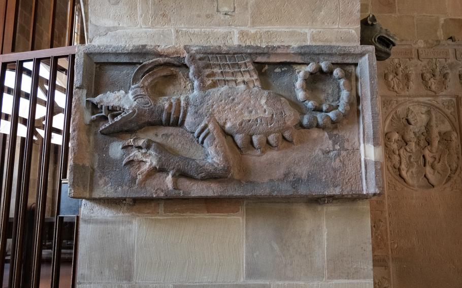 A dragon-like figure carved in stone is displayed inside St. Kilian’s Church, Heilbronn, Germany, July 6, 2023.