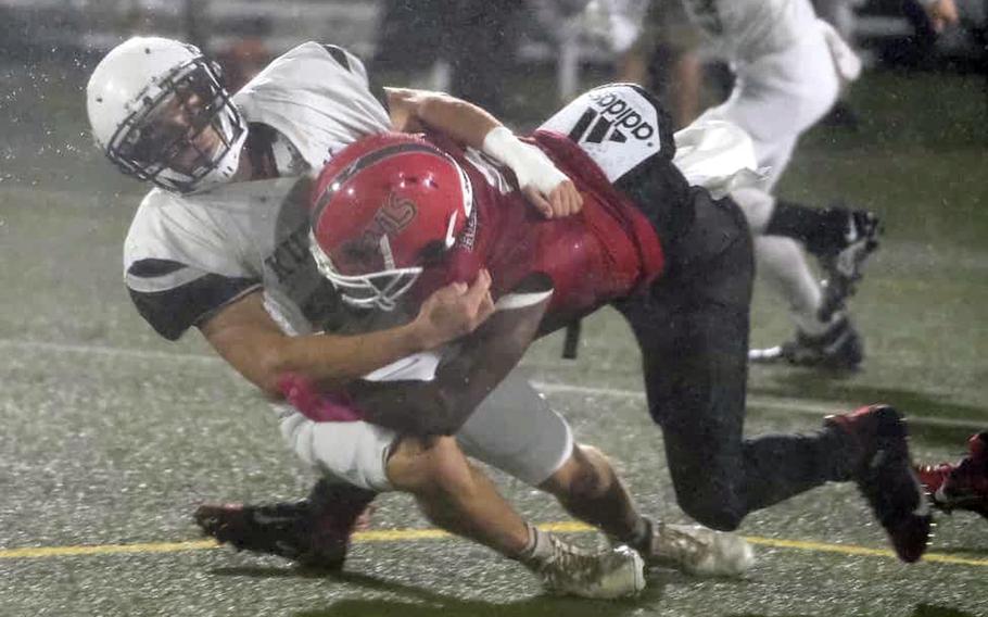 Kubasaki's Hayden Potter hauls down Nile C. Kinnick running back Wendell Harrison.