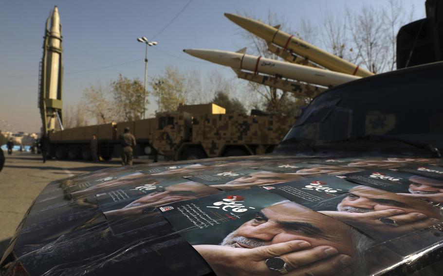 Posters of the late Iranian Gen. Qassem Soleimani are seen in Tehran, Iran, on Friday, Jan. 7, 2022, with three ballistic missiles on display in the background. Soleimani was killed in Iraq on Jan. 3, 2020, in a U.S. drone attack. 