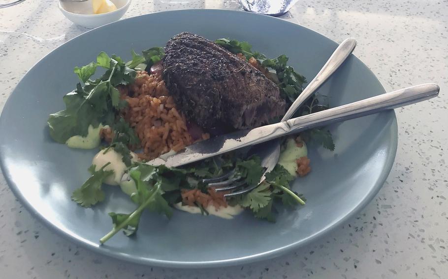 Spice-encrusted blackened tuna served with tomato rice, aioli, arugula mayo, pickled fennel and onions at Rali's Restaurant on Subic Bay, Philippines. 