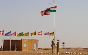 Nigerien and American flags are raised at the opening ceremony of Flintlock 2018 at Agadez, Niger on 11 April, 2018. Flintlock is U.S. Africa Command's premier and largest annual Special Operations Forces exercise.