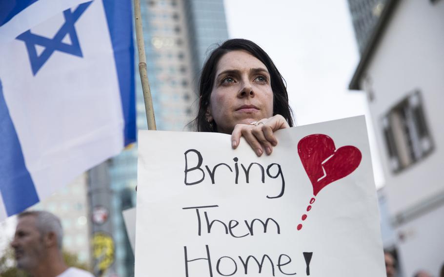 A woman holds a sign during a protest calling to bring back the hostages that were kidnaped during Hamas’ attack, on Thursday, Oct. 19, 2023, in Tel Aviv, Israel. 