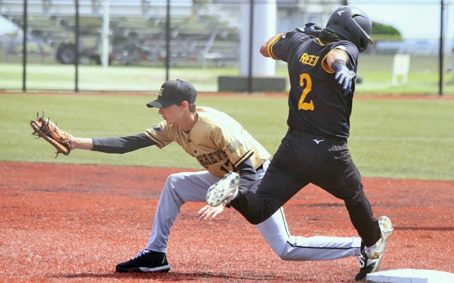 Kadena's Hajime Reed gets to first base too late to beat the throw to Humphreys' Beckett Babb. The Blackhawks won the fifth-place game against the Panthers.