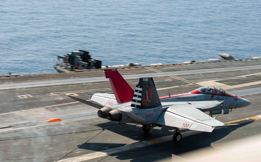 Navy Capt. Craig Sicola, commanding officer of the aircraft carrier USS Nimitz, front seat, and Cmdr. Luke Edwards, commanding officer of the “Fighting Redcocks” of Strike Fighter Squadron, make an arrested landing in an F/A-18F Super Hornet on April 22, 2023, in the South China Sea marking the 350,000th time the carrier has landed a fixed-wing aircraft on its flight deck. Nimitz is in U.S. 7th Fleet conducting routine operations. 7th Fleet is the U.S. Navy’s largest forward-deployed numbered fleet, and routinely interacts and operates with allies and partners in preserving a free and open Indo-Pacific region. 