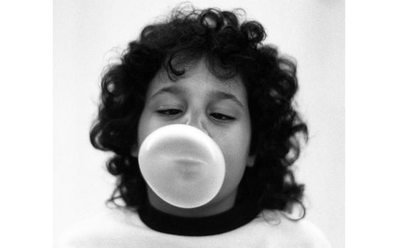 Frankfurt, West Germany, January, 1989: Nine-year-old Angela Duke concentrates on creating the perfect bubble-gum bubble during an after-school contest at the McNair Kaserne housing area.


Stars and Stripes celebrates the Month of the Military Child! Check out stories and drawings of dozens of "military brats" here.https://militarychild.stripes.com/

Check out the story and more bubbly photos here.
https://www.stripes.com/migration/bubble-fun-1.71317

Looking for Stars and Stripes’ historic coverage? Subscribe to Stars and Stripes’ historic newspaper archive! We have digitized our 1948-1999 European and Pacific editions, as well as several of our WWII editions and made them available online through https://starsandstripes.newspaperarchive.com/

META TAGS: Month of Military Child; military brat; military family