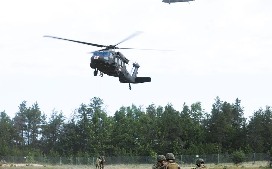 The Personnel Retrieval and Processing Company, Combat Logistics Battalion 45, headquartered out of Smyrna, Ga., are hoisted in the air by a UH-60 Black Hawk helicopter flown by soldiers of the 2nd Battalion, 104th Regiment, Nebraska National Guard during exercise Northern Strike 2023 on Camp Grayling, Mich., Aug. 10, 2023. 