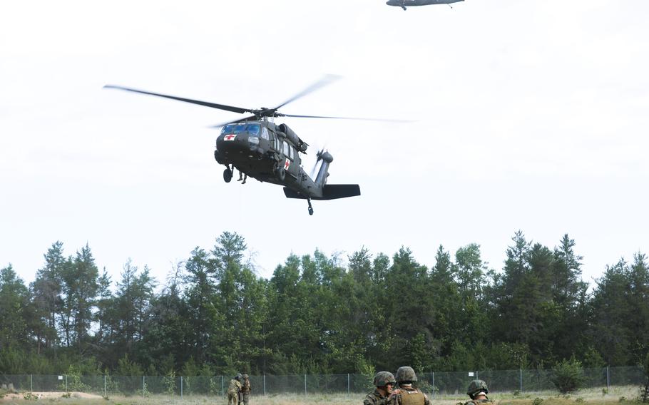The Personnel Retrieval and Processing Company, Combat Logistics Battalion 45, headquartered out of Smyrna, Ga., are hoisted in the air by a UH-60 Black Hawk helicopter flown by soldiers of the 2nd Battalion, 104th Regiment, Nebraska National Guard during exercise Northern Strike 2023 on Camp Grayling, Mich., Aug. 10, 2023. 