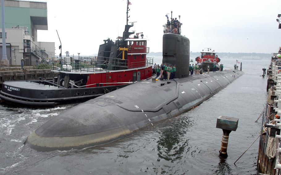 The USS Virginia returns to the Electric Boat Shipyard in Groton Conn., after its first sea trials in July 2004. A Navy nuclear engineer and his wife have been charged with repeatedly trying to pass along secrets on the design, operations and performance of Virginia-class nuclear submarine reactors, according to court documents.