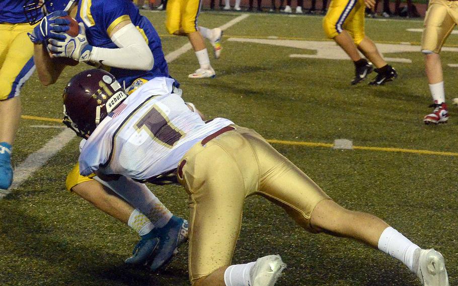 Yokota's Caleb Jones gets corraled by Matthew C. Perry's Jordan Wooten.