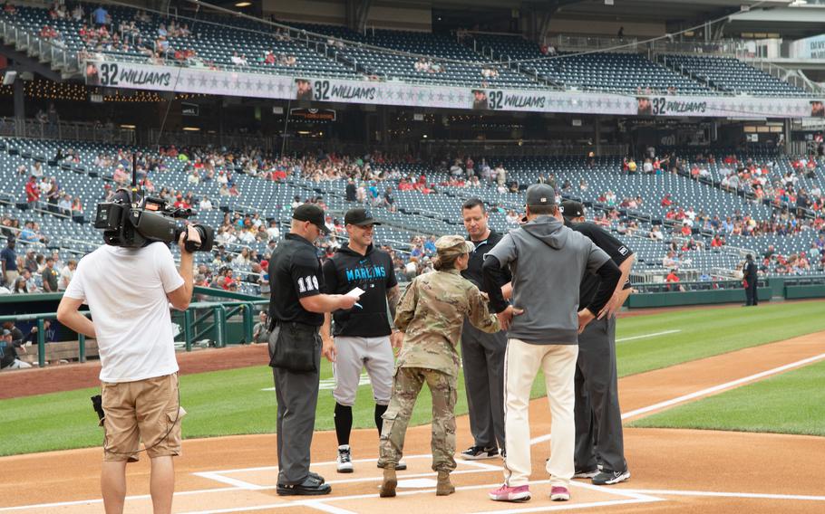 Maj. Gen. Michele H. Bredenkamp joins coaches and umpires at home plate during U.S. Army Day at Nationals Park in Washington, D.C., on Friday, June 16, 2023. The Nationals hosted the Miami Marlins.