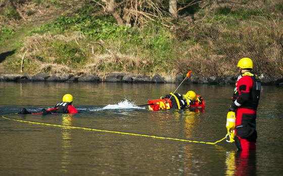 Firefighters demonstrate EMILY — the Emergency Integrated Lifesaving Lanyard — on the Nishiki River in Iwakuni, Japan, on Feb. 13, 2024.