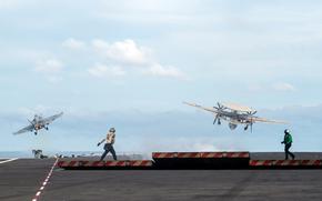 An F/A-18E Super Hornet, left, and an E-2D Hawkeye launch off the flight deck of the aircraft carrier USS Ronald Reagan in waters east of the Korean Peninsula, Sept. 28, 2022.