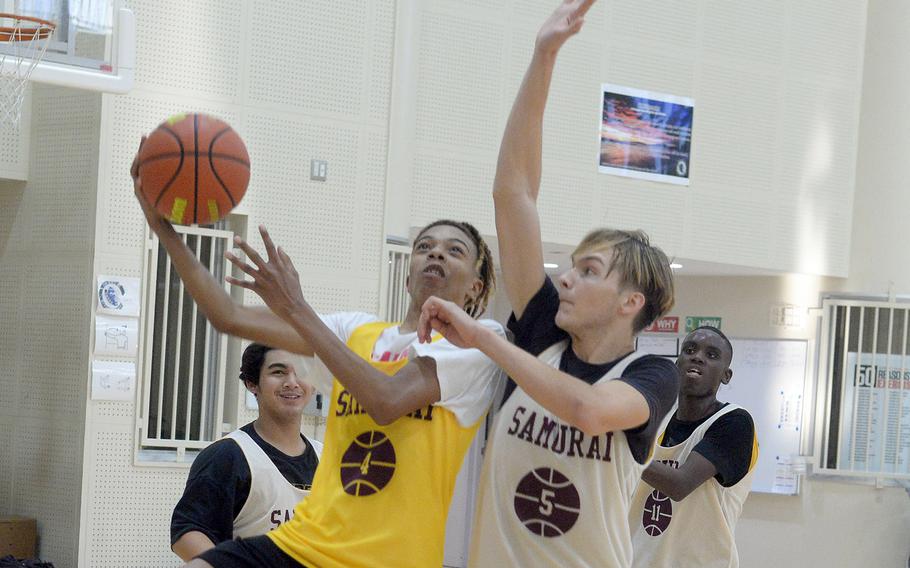 Matthew C. Perry junior Billy Hill takes it to the basket against junior teammate Joshua Norris.