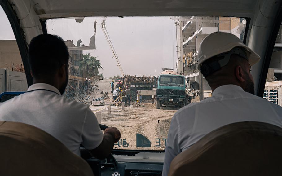 A manager of the sprawling Iraq Gate residential complex, still partially under construction even as several buildings are already inhabited, surveys a construction site in September 2022.