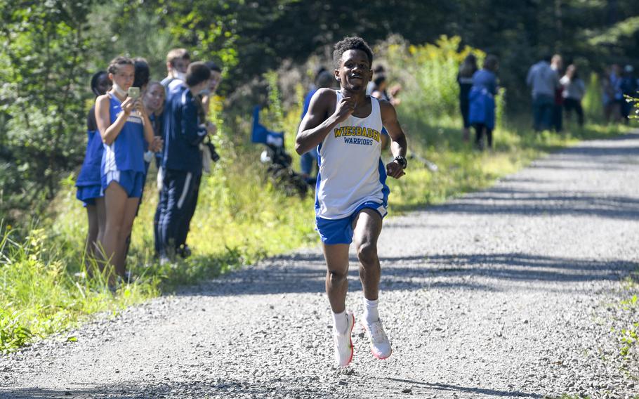 Elijah Smith, a runner for Wiesbaden High School, flies toward the finish line as the winner of the high school boys’ varsity cross country race Sept. 18, 2021, in Kaiserslautern, Germany.