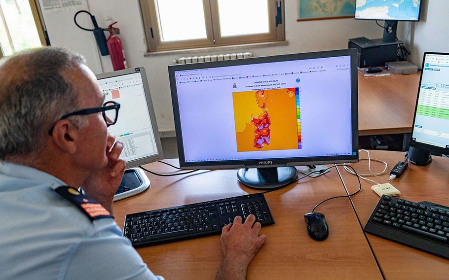 A data-collection desk reviews a map of Sardinia at a weather station inside an Italian Air Force base during this month’s heat wave. 