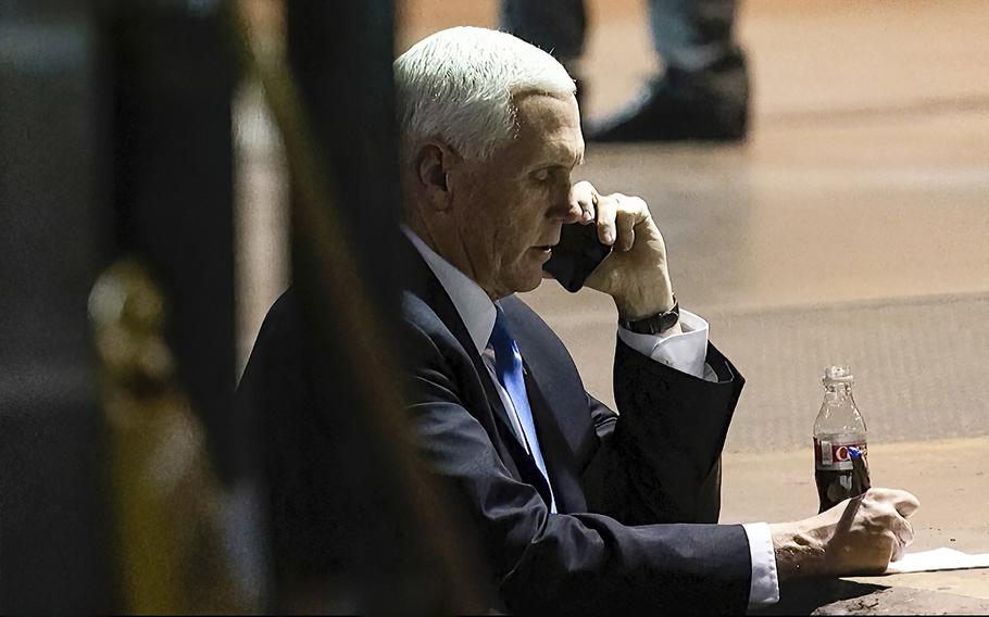 In this image from video released by the House Select Committee, Vice President Mike Pence talks on a phone from his secure evacuation location on Jan. 6, 2021.