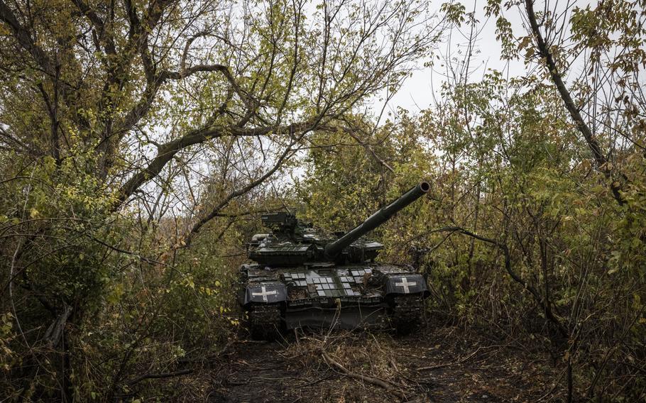 A T-64BV tank is parked under trees on Oct. 20, 2023, in Ukraine’s Kharkiv region. 