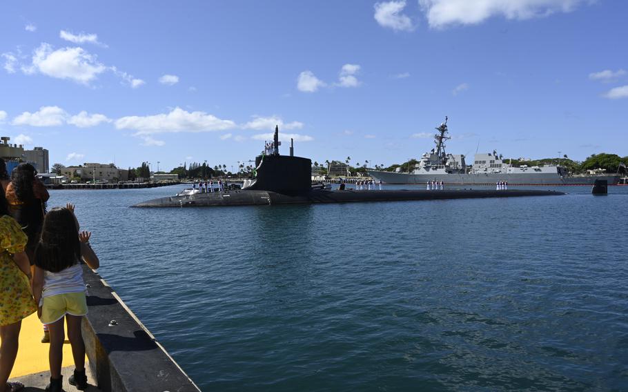 Family members greet the Virginia-class, fast-attack submarine USS Vermont as it arrives July 27, 2023, at Joint Base Pearl Harbor-Hickam, Hawaii. Three new Virginia-class subs will be named for three battleships sunk and never salvaged from the Japanese attack on Pearl Harbor on Dec. 7, 1941.