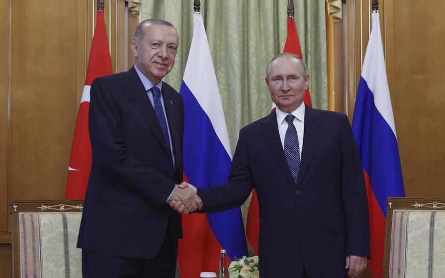 In this handout photo provided by the Turkish Presidency, Turkish President Recep Tayyip Erdogan, left, and Russian President Vladimir Putin shake hands prior to their meeting at the Rus sanatorium in the Black Sea resort of Sochi, Russia, Friday, Aug. 5, 2022.