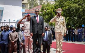 New President of Somalia Hassan Sheikh Mohamud, center, inspects a military honor guard during an official handover ceremony at the presidential palace in Mogadishu, Somalia, Monday, May 23, 2022. Mohamud was elected to the nation's top office in a protracted contest decided by legislators on Sunday, May 15, 2022. (AP Photo/Farah Abdi Warsameh)