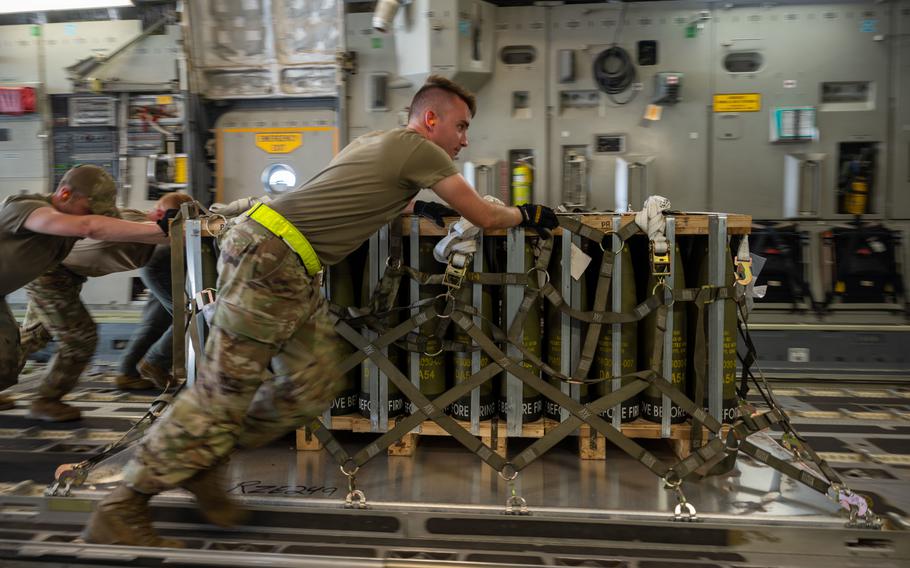 Airmen on Aug. 9, 2022, load pallets of ammunition onto a C-17 Globemaster III bound for Ukraine during a security assistance mission at Dover Air Force Base, Del. The Defense Department is providing Ukraine with weapons and equipment to defend against invading Russian forces.