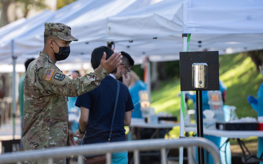 Hawaii Army National Guard Soldier Spc. Jonathan M. Ganir with Task Force Medical (TF MED), Hawaii National Guard Joint Task Force provided line flow control for patients awaiting their turn to receive a coronavirus test at the Waikīkī Shell, Honolulu, Hawaii, Jan. 10, 2022. 