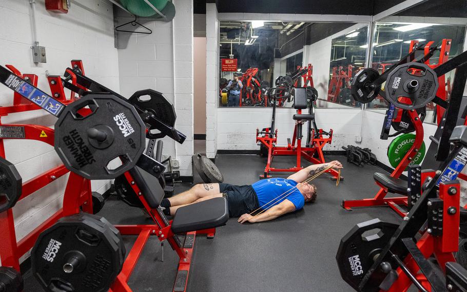 A Marine works out in a gym