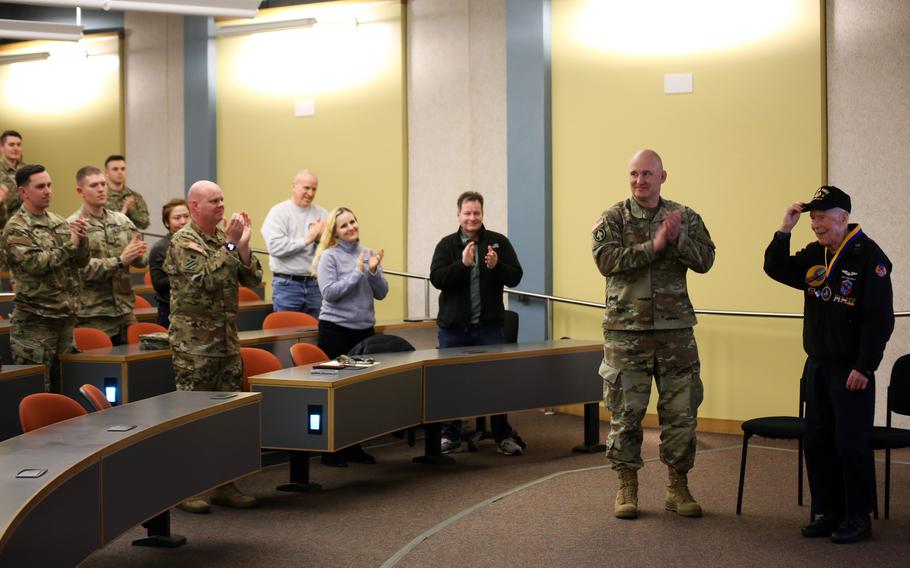 Brig. Gen. David Doran, assistant director, Army National Guard for Aviation, Intelligence and Information and Capt. Dick Nelms, World War II pilot join soldiers from the Washington Army National Guard for a presentation of the Knight of the Honorable Order of Saint Michael award at the Washington Army National Guard Aviation Readiness Center, Joint Base Lewis-McChord, Wash., on Sunday, March, 3, 2024.