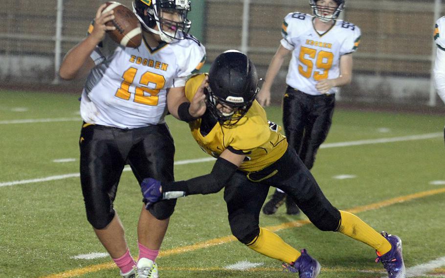 Robert D. Edgren quarterback Jayse Ulechong gets chased down by American School In Japan's Isreal Rodriguez, one of three sacks by the Mustangs.