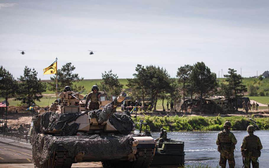 U.S. soldiers and their NATO allies complete a wet-gap crossing  in Nowogrod, Poland, on May 19, 2022. The Pentagon has relied heavily on rotational forces to boost troop numbers in Europe, but that may change if a permanent basing model is adopted on the Continent.