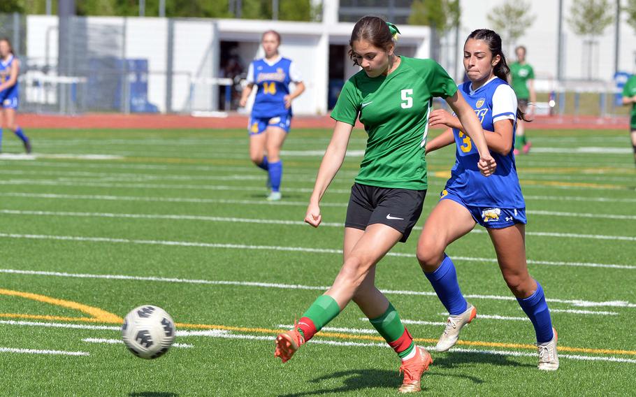 Alconbury’s Sofia Politis shoots on goal after getting past Sigonella’s Keila Fuentes in the girls Division III finals at the DODEA-Europe soccer finals in Ramstein, Germany, May 18, 2023. Sigonella won 4-2.