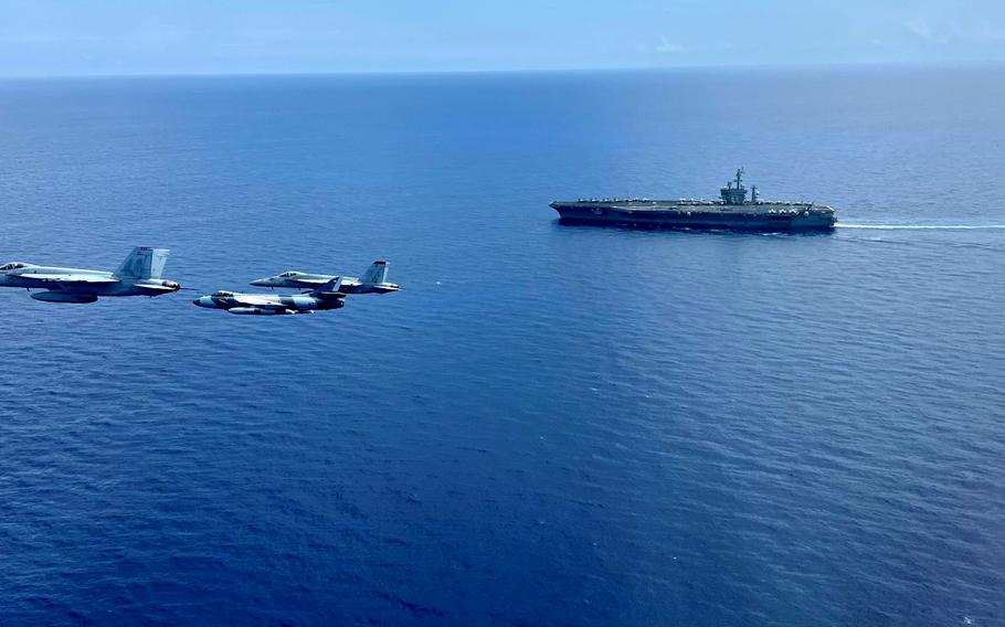 Two F/A-18E Super Hornets and a Hawker Hunter fly near the USS Dwight D. Eisenhower in the Atlantic Ocean on July 14, 2023. The Italian frigate ITS Virginio Fasan will deploy with the Dwight D. Eisenhower Carrier Strike Group in the Mediterranean Sea this fall, according to Italian officials.