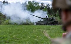 A U.S. Soldier watches Ukrainian artillerymen fire the M109 self-propelled howitzer at Grafenwoehr Training Area, Germany, May 12, 2022. Soldiers from the U.S. and Norway trained Armed Forces of Ukraine artillerymen on the howitzers as part of security assistance packages from their respective countries. (U.S. Army photo by Sgt. Spencer Rhodes, 53rd Infantry Brigade Combat Team)