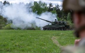 A U.S. Soldier watches Ukrainian artillerymen fire the M109 self-propelled howitzer at Grafenwoehr Training Area, Germany, May 12, 2022. Soldiers from the U.S. and Norway trained Armed Forces of Ukraine artillerymen on the howitzers as part of security assistance packages from their respective countries. (U.S. Army photo by Sgt. Spencer Rhodes, 53rd Infantry Brigade Combat Team)