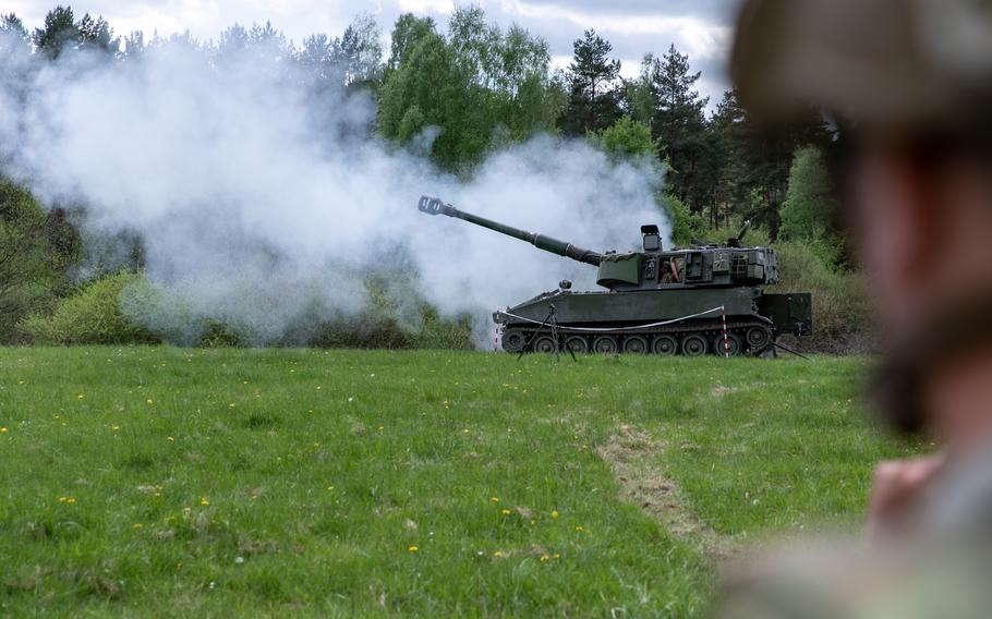 A U.S. soldier watches Ukrainian artillerymen fire the M109 self-propelled howitzer at Grafenwoehr Training Area, Germany, May 12, 2022. Soldiers from the U.S. and Norway trained Armed Forces of Ukraine artillerymen on the howitzers as part of security assistance packages from their respective countries. 