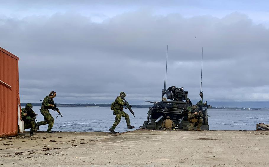 Sailors and Marines of the II Marine Expeditionary Force and members of Sweden's 1st Marine Regiment participate in a simulated withdrawal of forces, or hot pick-up, as part of the joint military exercise Archipelago Endeavor 23  near Berga, Sweden, on Wednesday, Sept. 13, 2023.