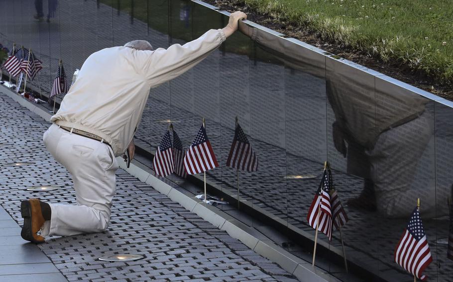 A visitor to the Vietnam Veterans Memorial in Washington, D.C., pays his respects on Memorial Day, May 31, 2021.