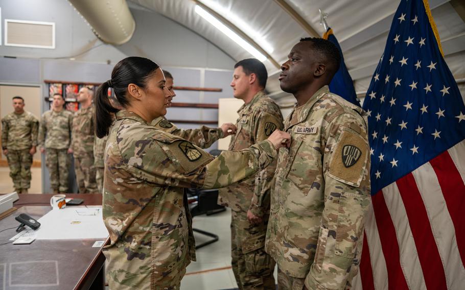 Army Sgts. 1st Class Roshawn Constantine and Yevgeniy Parakhin are promoted Feb. 23, 2023, during a ceremony at Camp Arifjan, Kuwait. Constantine and Parakhin were promoted from the rank of staff sergeant.