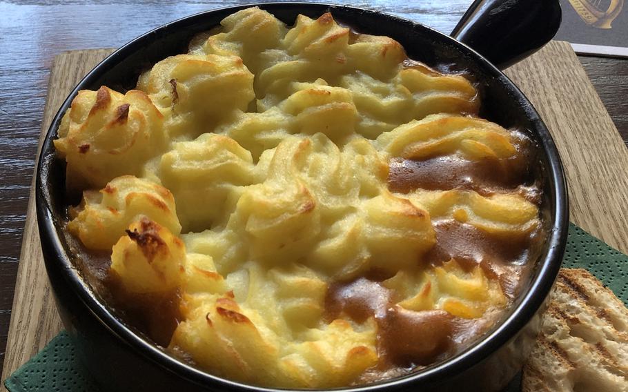 The traditional homemade cottage pie with ground Irish beef, onions, celery and carrots, in a gravy and red wine sauce, topped with mashed potatoes, with toasted bread and butter, as served at Waxy’s Irish Pub in Frankfurt, Germany.