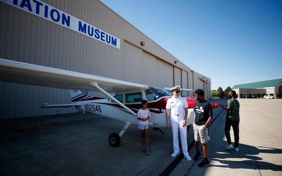 Ensign Lincoln Kilgore talks with camp goer Joel Desmennu before Desmennu and others go up in a plane during the Aviation Summer Camp on Friday, June 24, 2022, at the Aviation Museum at Bluegrass Airport in Lexington, Ky.