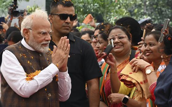 Indian Prime Minister Narendra Modi is welcomed at the Bharatiya Janata Party headquarters, where he was felicitated a day after the women's reservation bill was passed by the Indian Parliament in New Delhi, Friday, Sep. 22, 2023. (AP Photo/STR)