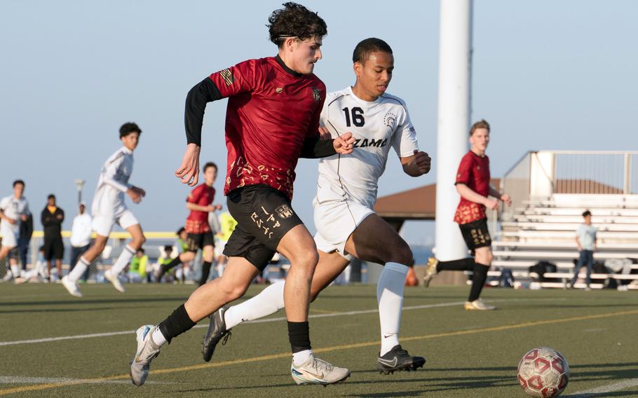Esteban Diaz and Chris Jones run after the ball.