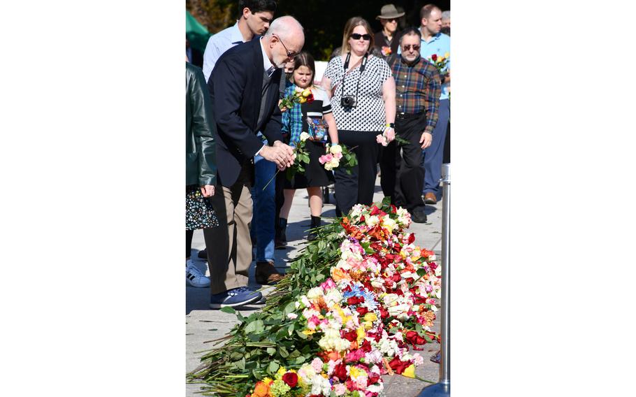 Visitors stack flowers in front of the Tomb of the Unknown Soldier on Wednesday, Nov. 10, 2021, during a ceremony to commemorate the tomb’s 100th anniversary.