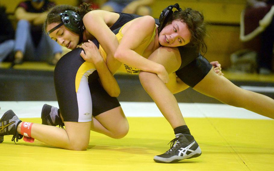Kubasaki's Janelle Heinrich and Kadena's Mylein Tull battle for the upper hand at 115 pounds during Wednesday's Okinawa wrestling dual meet. Tull scored the last point to win by decision 7-7 and the Panthers won the meet 30-28.