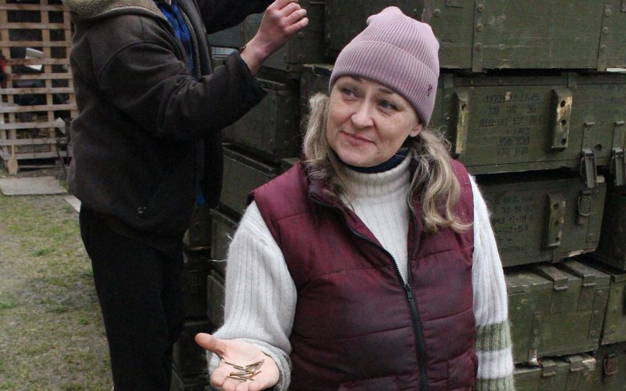 Svitlana Chmut holds fléchettes, small arrow-like projectiles dispersed by a Russian artillery shell, in Bucha, Ukraine, on April 16, 2022.