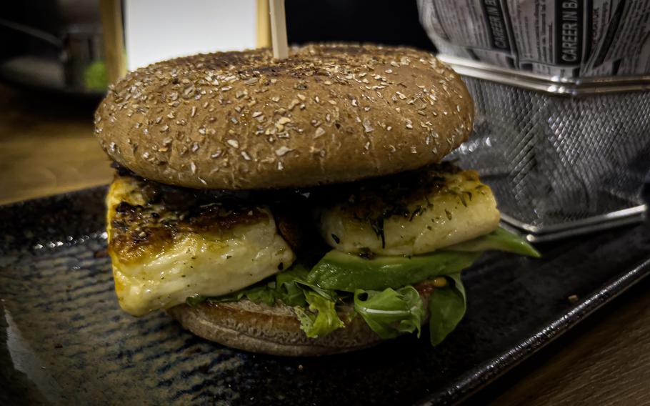 The Alte Post's signature veggie burger, featuring a grilled cheese patty in a rye bun, Dec. 20, 2023, in Neckarsulm, Germany. It's served with cognac cocktail sauce, grilled vegetables, avocado, arugula and battered sweet potato fries.