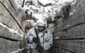 An armed serviceman walks along a trench on the territory controlled by pro-Russian militants on the frontline with Ukrainian government forces near Spartak village in Yasynuvata district of Donetsk region, eastern Ukraine, Thursday, Jan. 27, 2022. Fighting between Ukrainian forces and Russia-backed rebels has killed over 14,000 people, and efforts to reach a settlement have stalled. Since the conflict began, Russia has been accused of sending troops and weapons to the separatists, something it has denied. (AP Photo/Alexei Alexandrov)