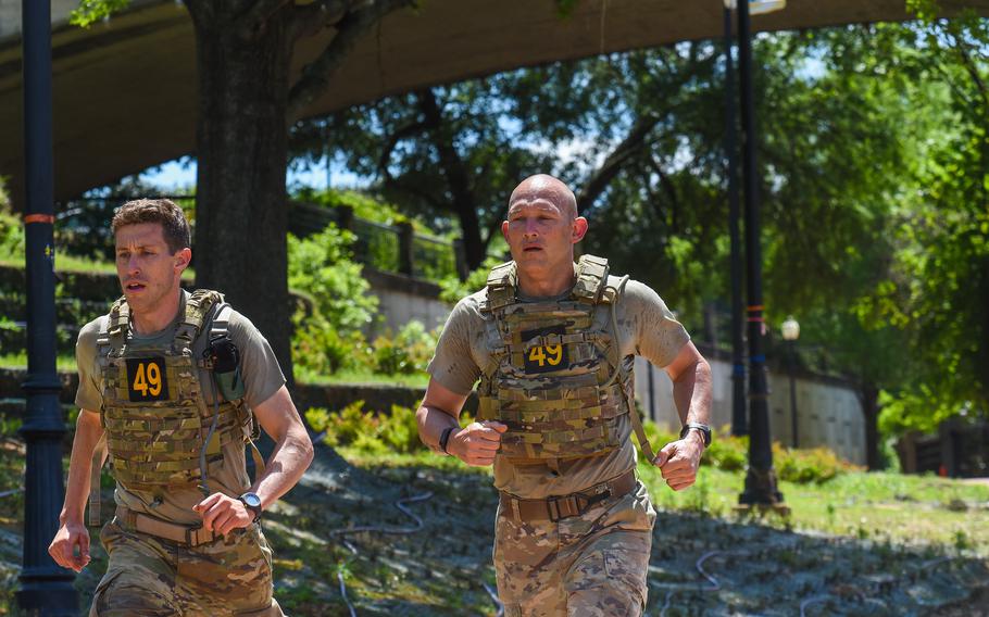 Best Ranger Competition Team 49, Maj. Nathaniel Bishop and Master Sgt. Justin Kline of 1st Army, run through downtown Columbus, Ga., on the second day of the competition, Saturday, April 15, 2023. 